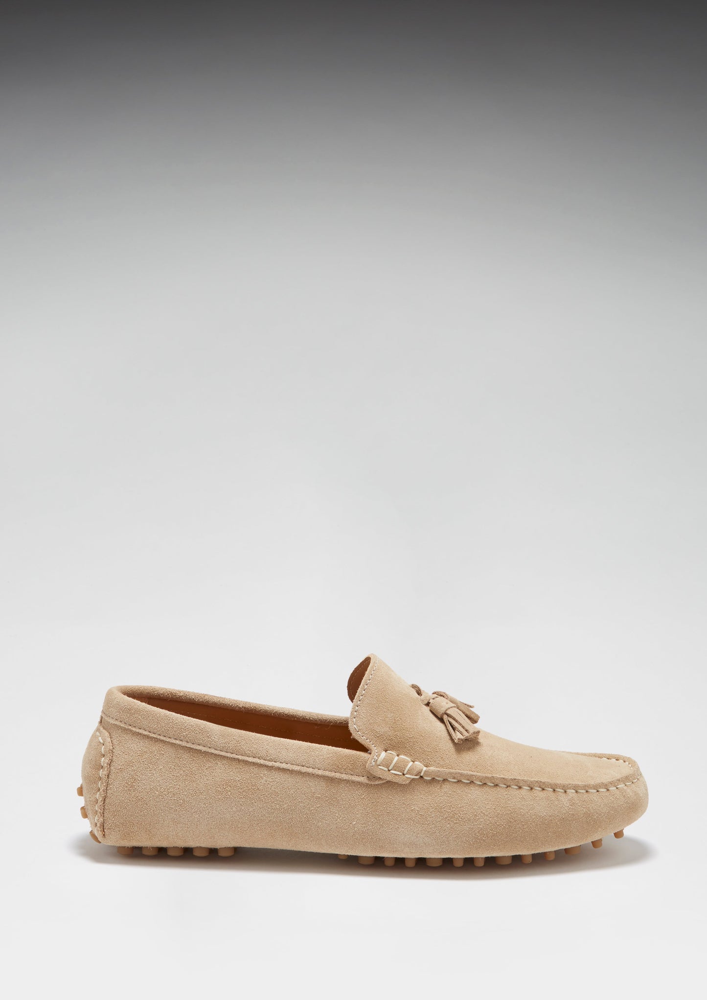Beige loafer shoe on a light gray background