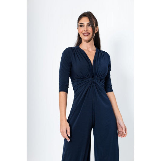 Woman wearing a navy blue jumpsuit on a white background