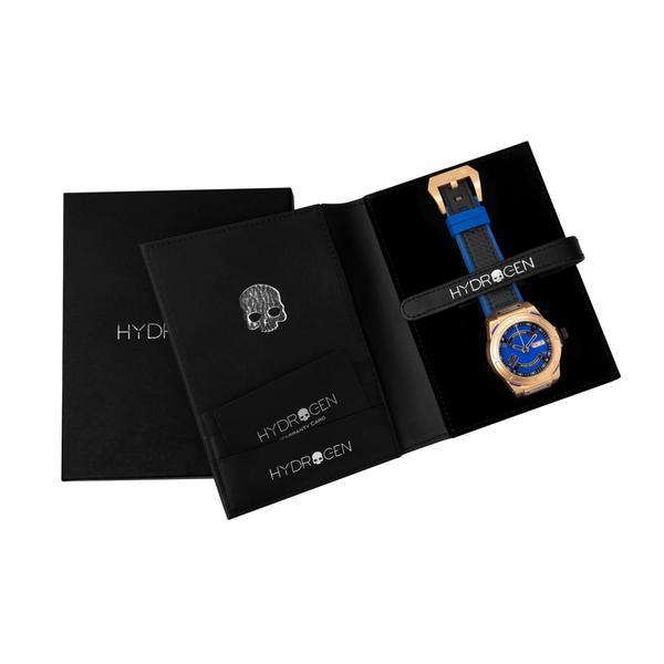 Watch with blue face and rose gold accents in a black Hydrogen box on a white background