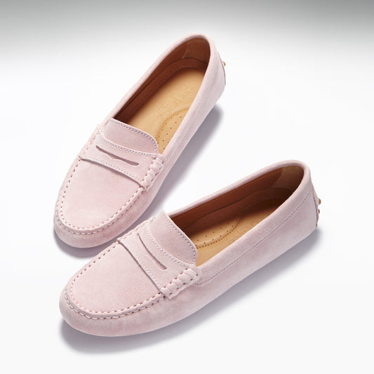 Pink loafers on white background
