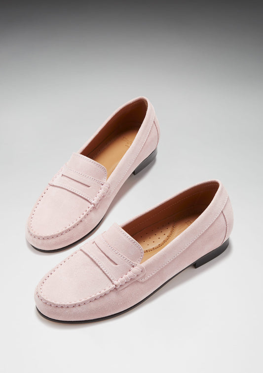 Pair of pink loafers on a light gray background