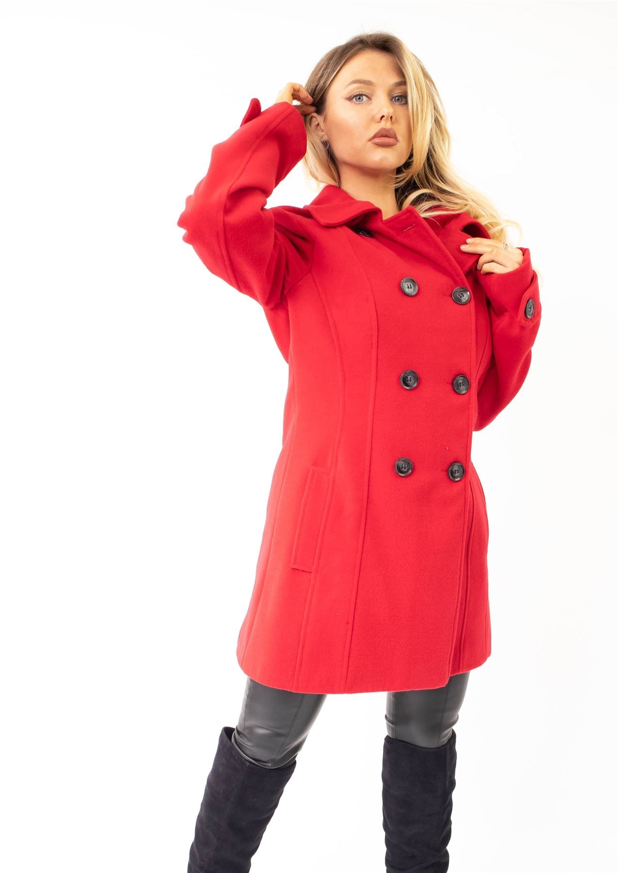 Woman wearing a red coat with black buttons on a white background