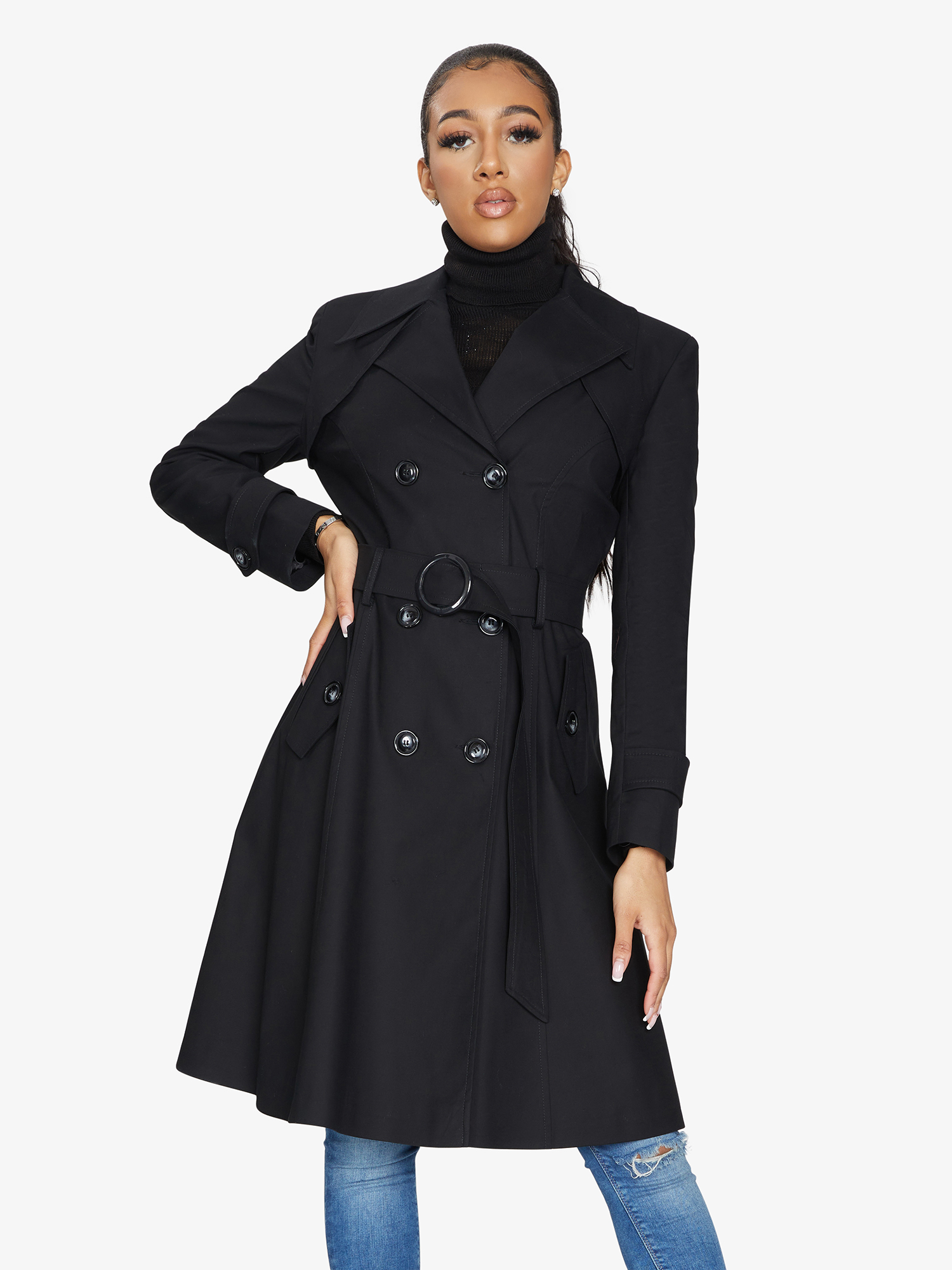 Woman wearing a black trench coat on a white background