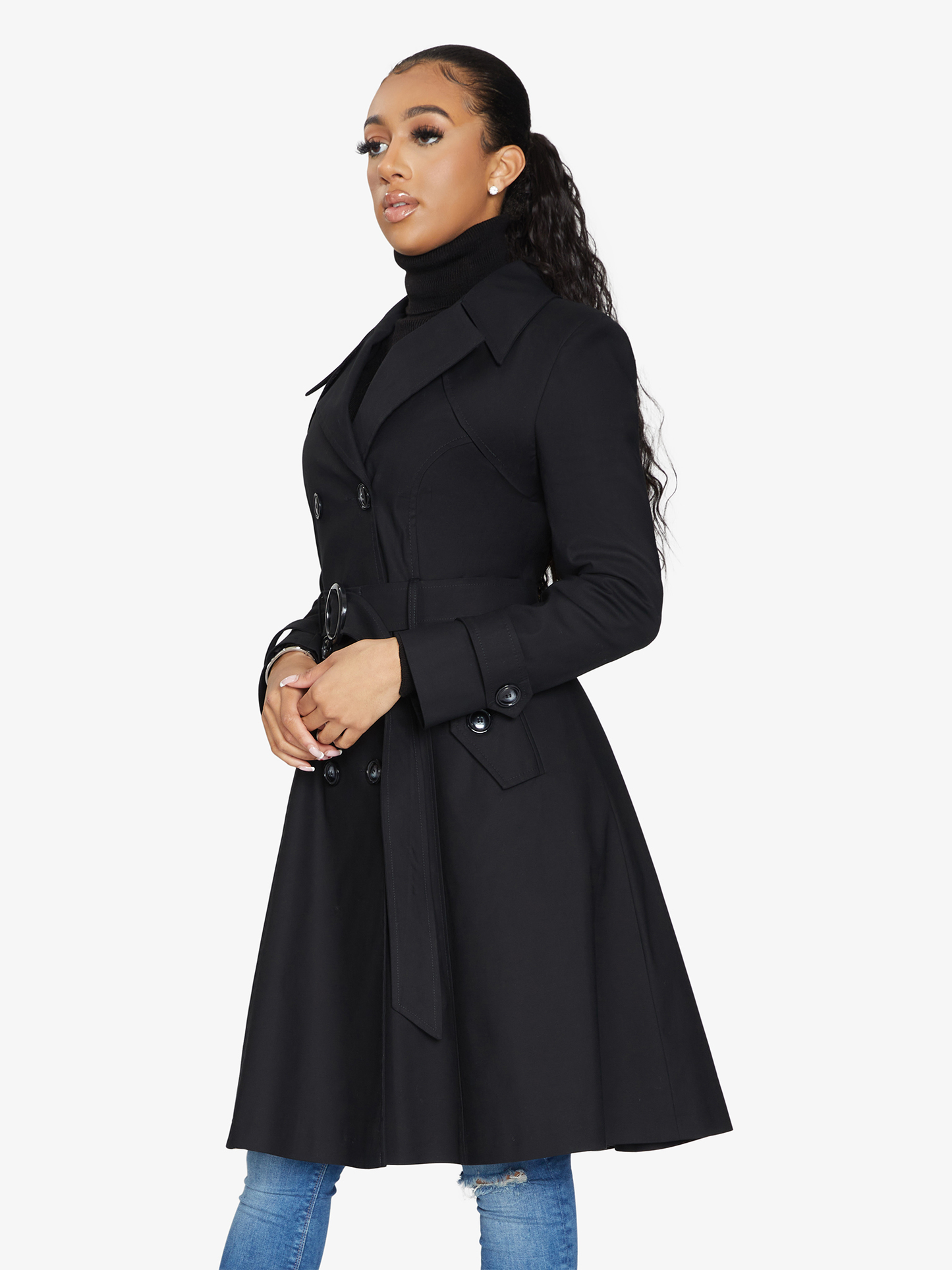 Woman wearing a black coat on a white background