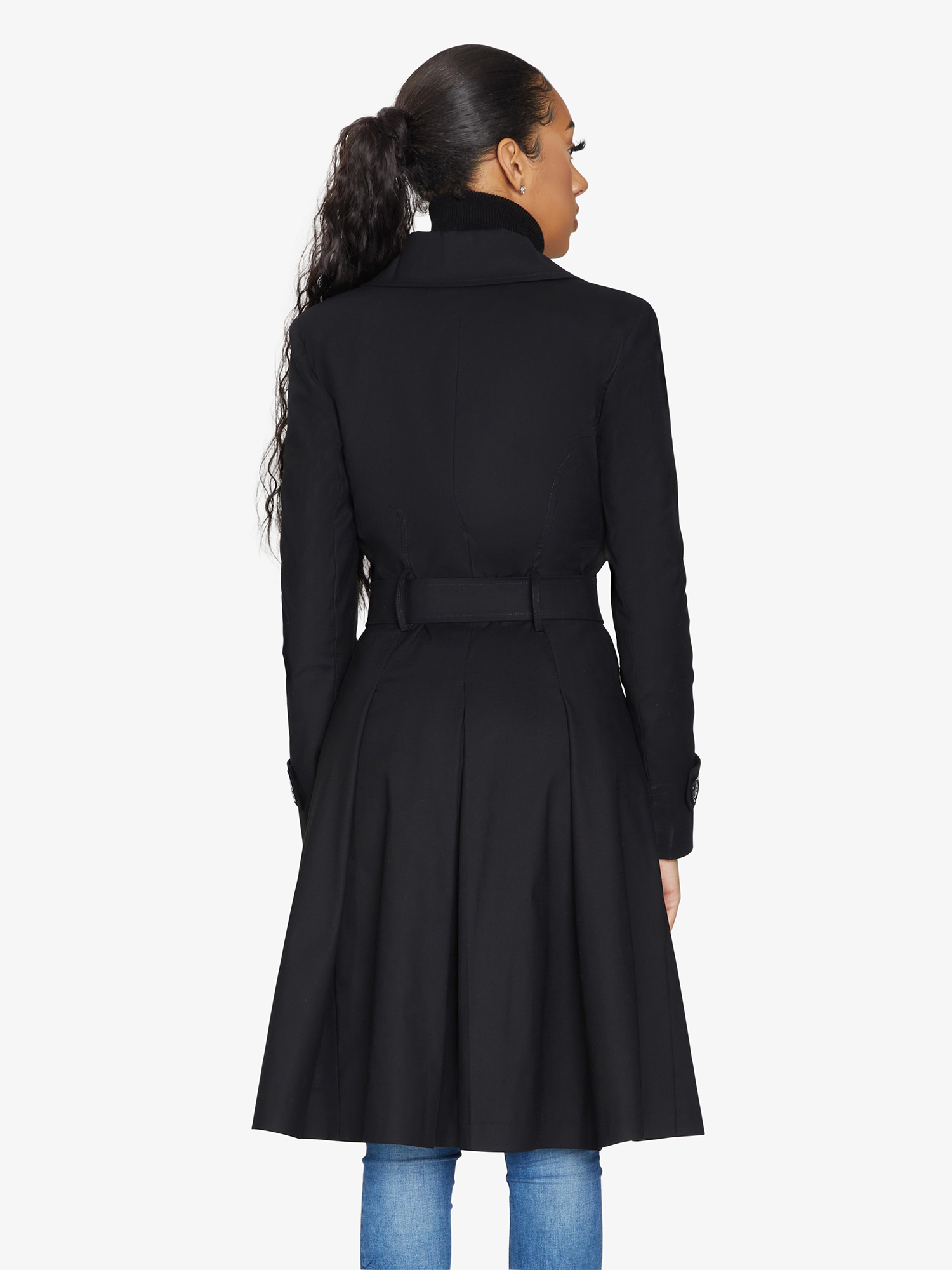 Woman wearing a black coat on a white background