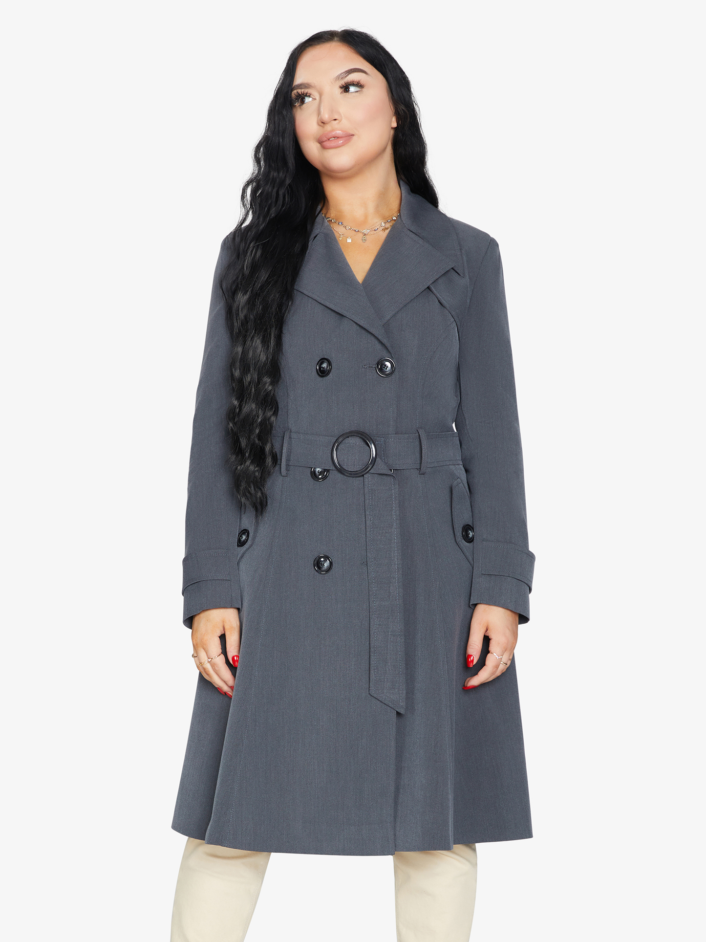 Woman wearing a gray trench coat on a white background