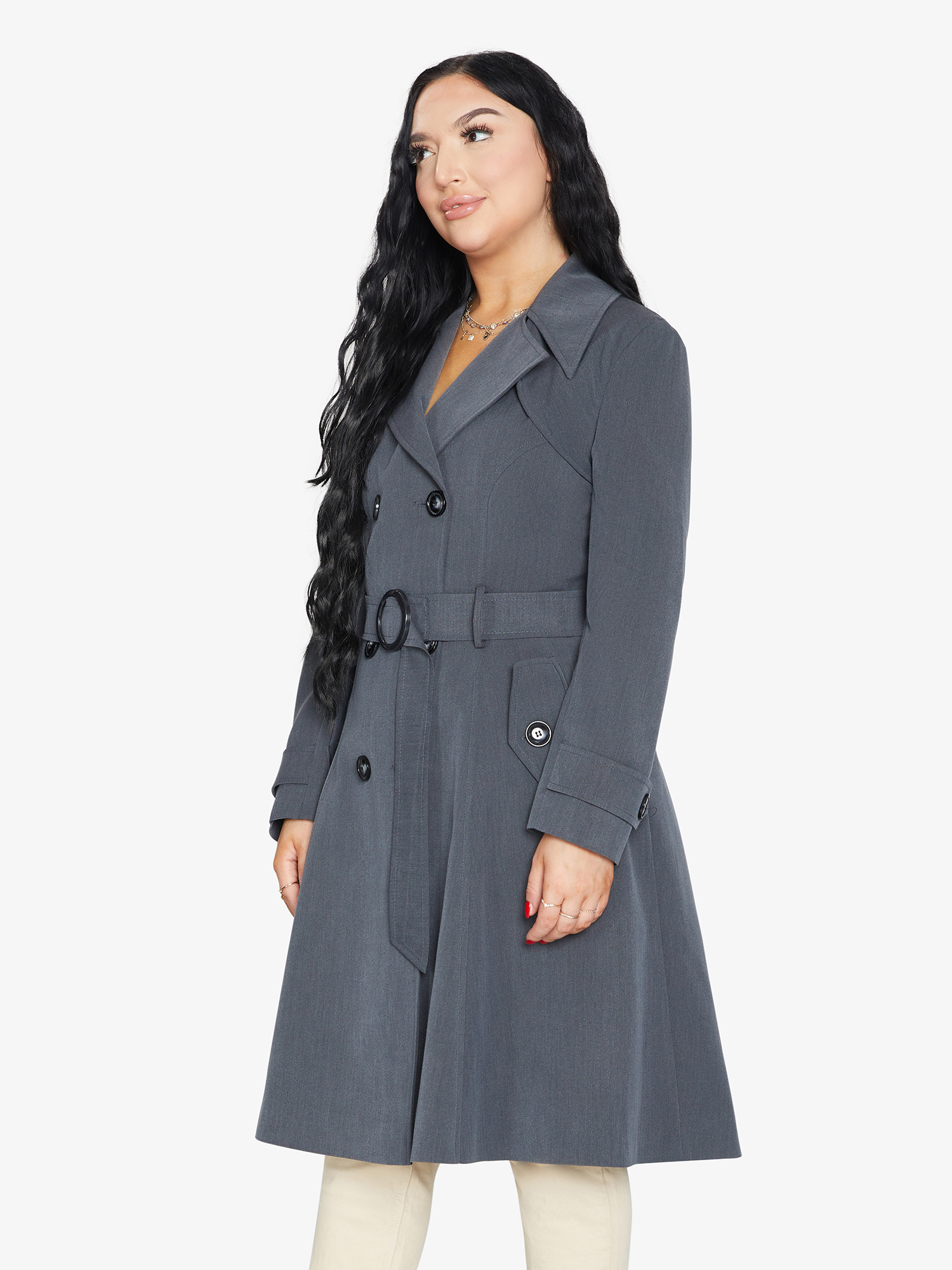 Woman wearing a gray trench coat on a white background