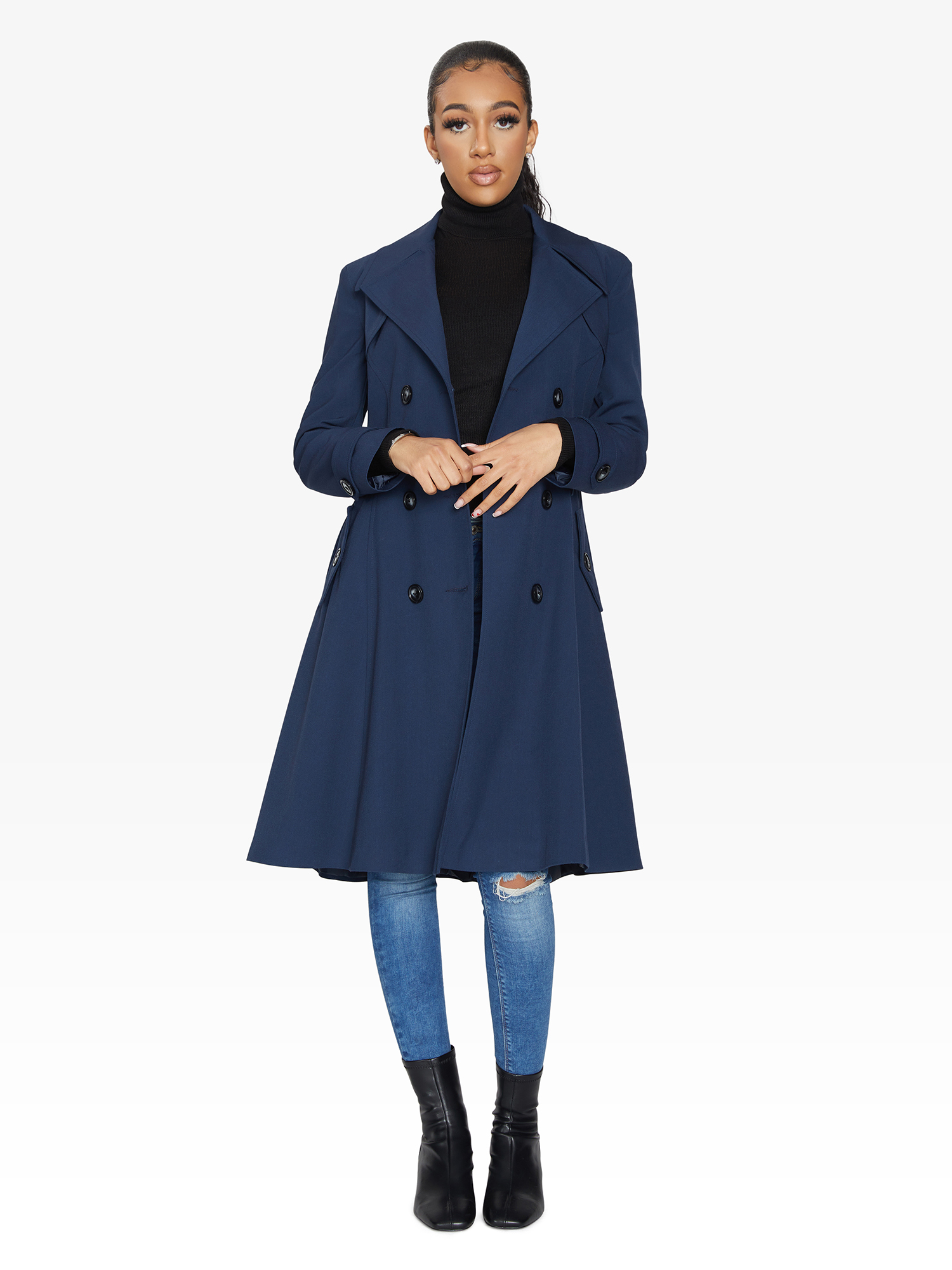 Woman wearing a blue coat on a white background