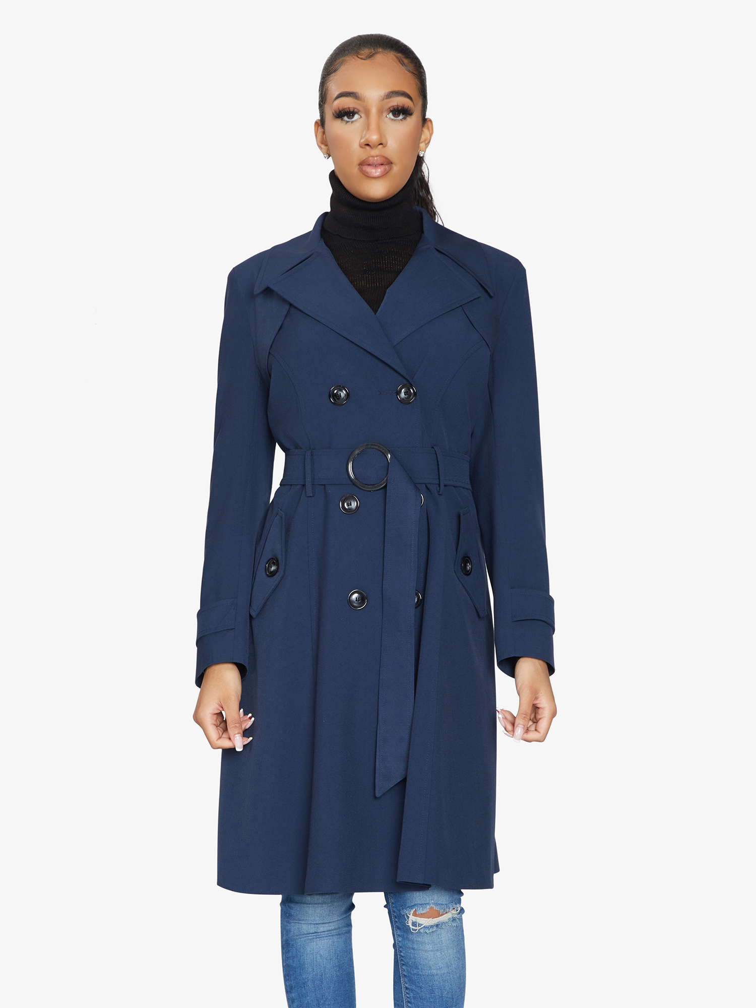 Woman wearing a blue trench coat on a white background