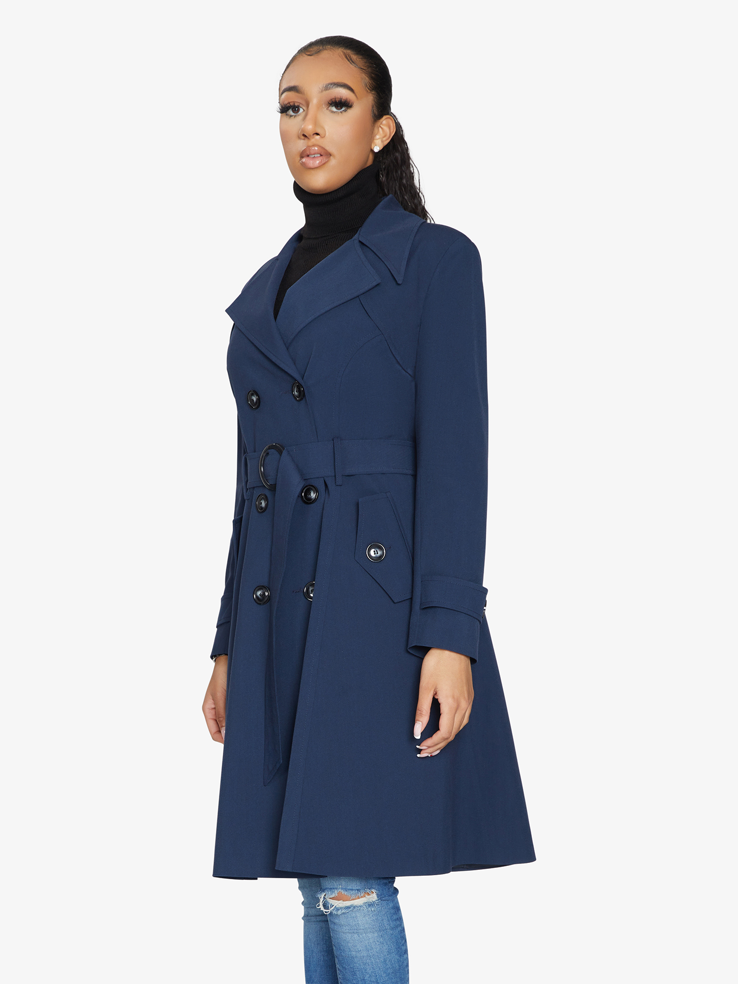Woman wearing a blue trench coat on a white background