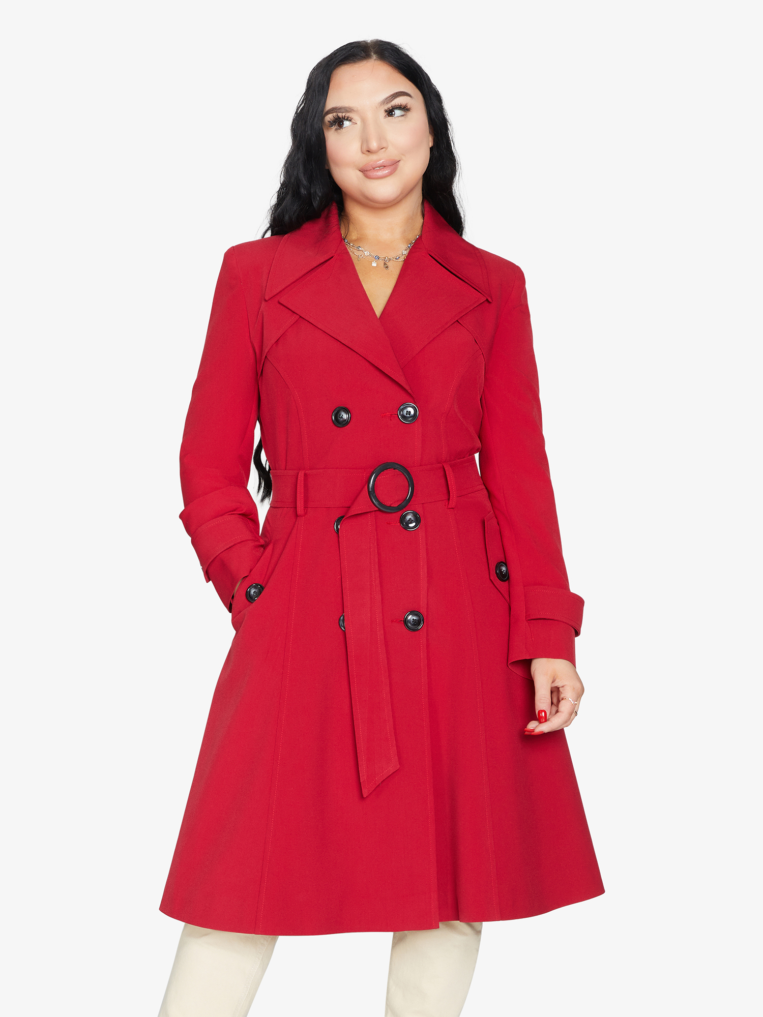 Woman wearing a red coat with black buttons on a white background