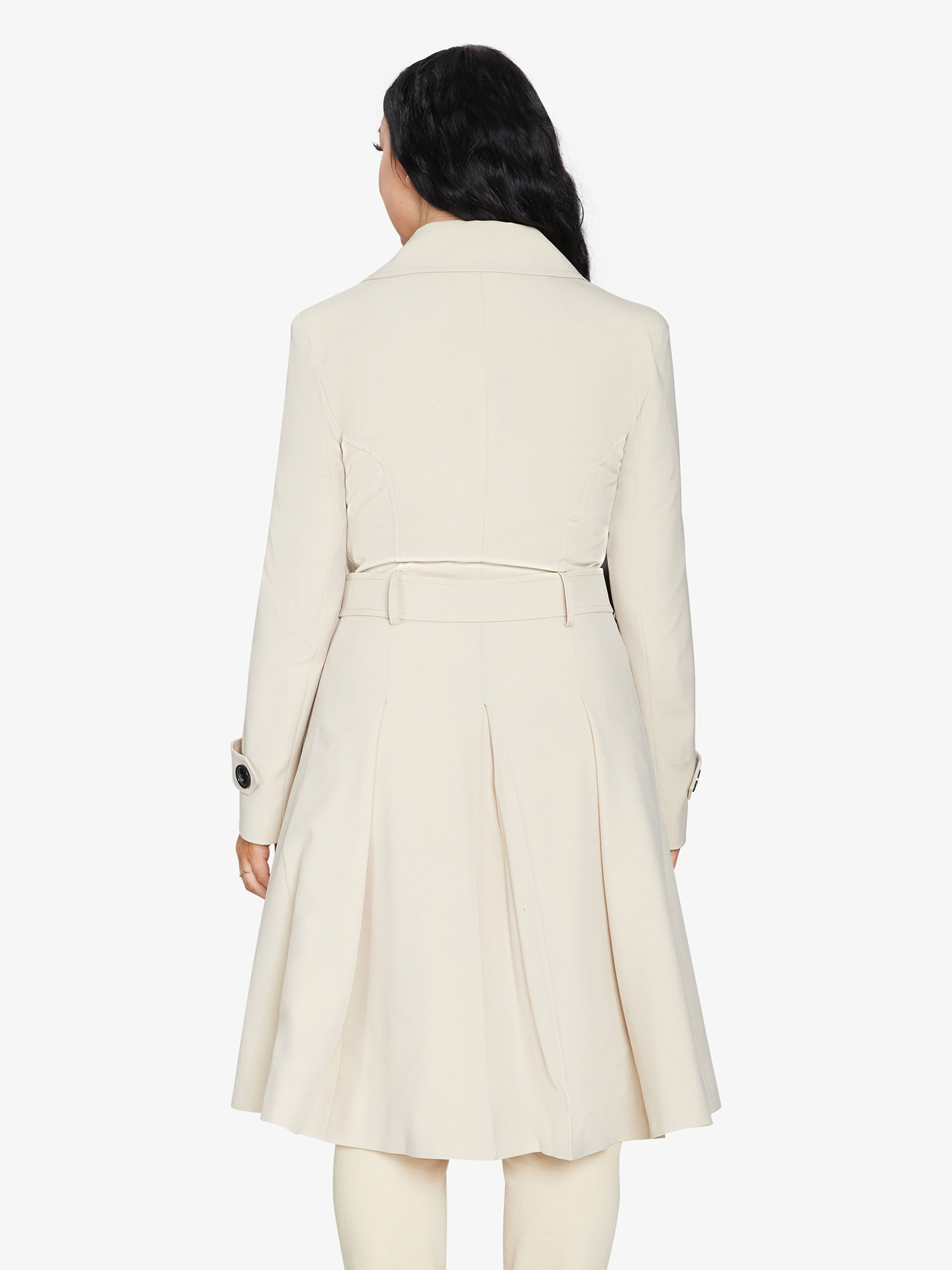 Person wearing a cream-colored coat on a white background