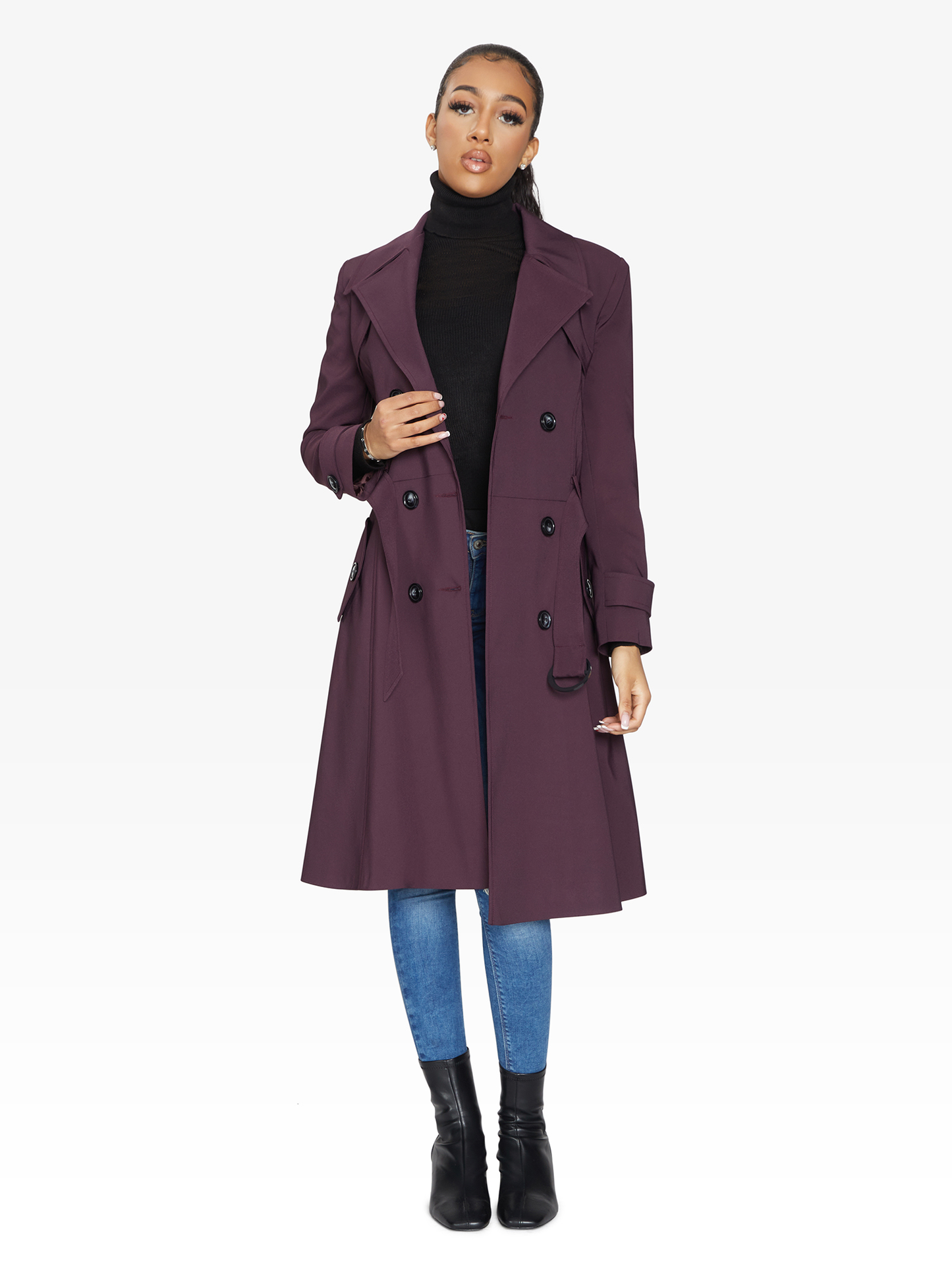 Woman wearing a purple coat on a white background