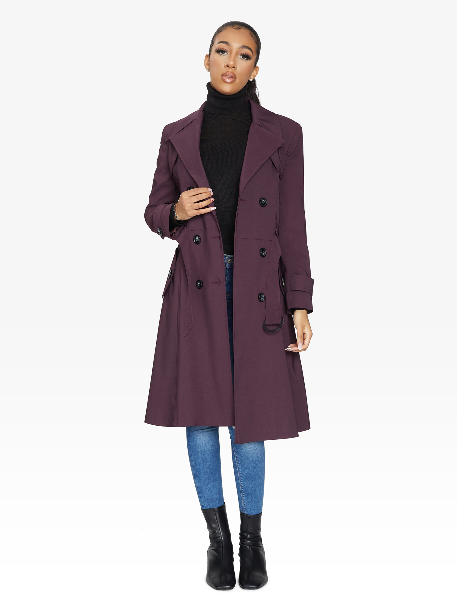 Woman wearing a purple coat on a white background