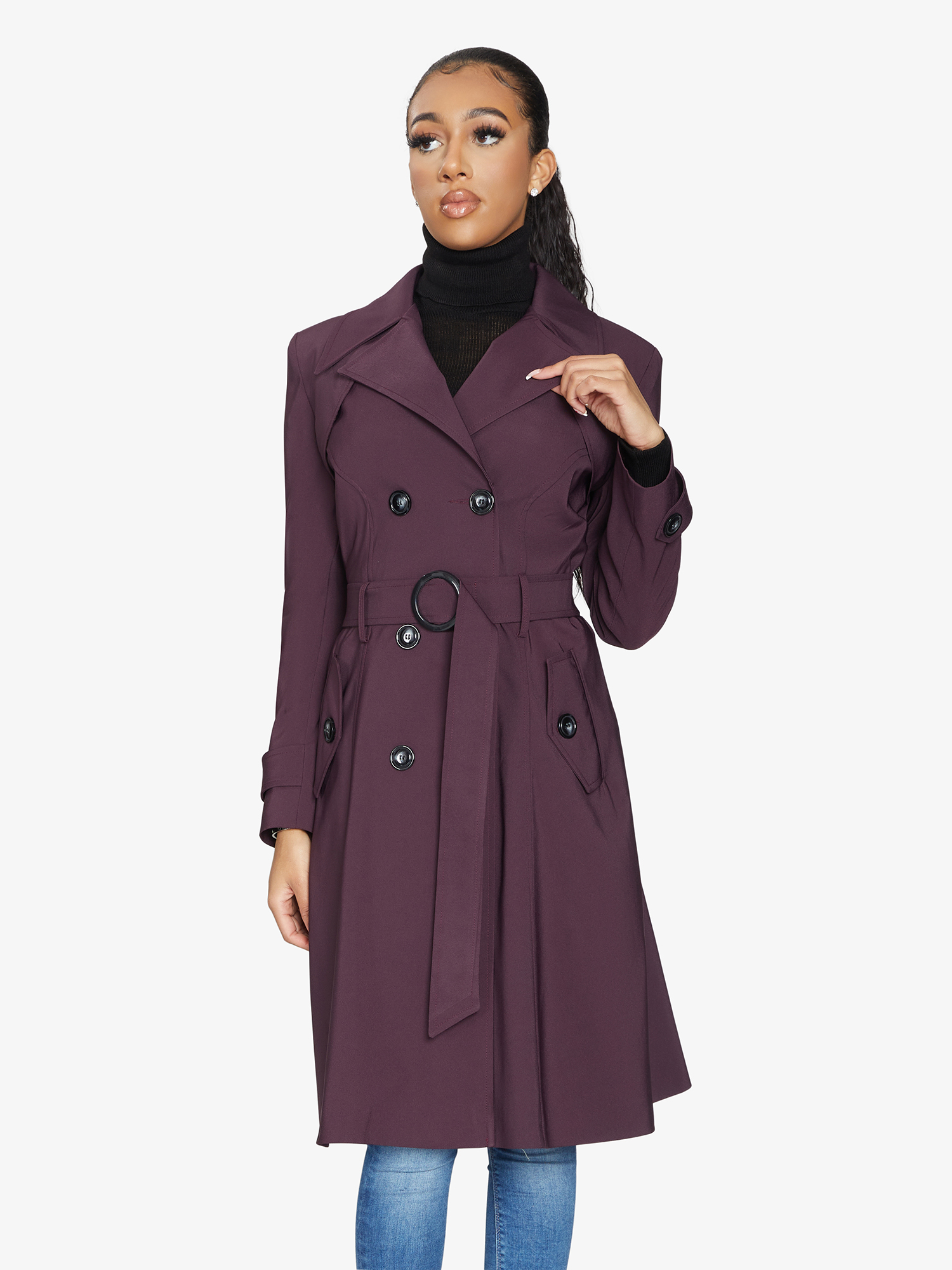 Woman wearing a purple trench coat on a white background