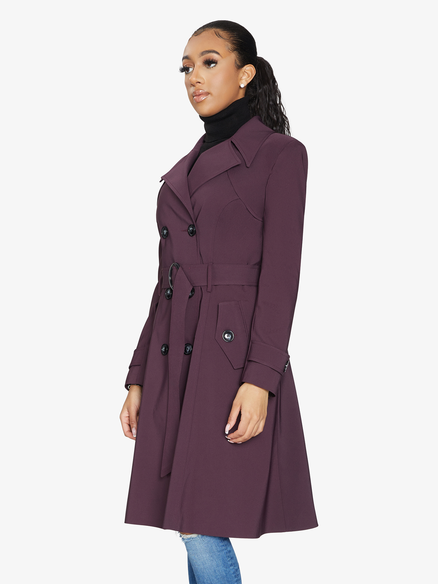 Woman wearing a purple trench coat on a white background