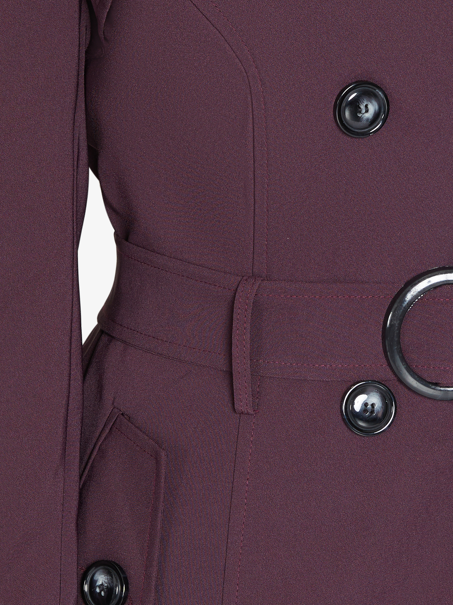 Close-up of a purple coat with buttons and a belt on a white background
