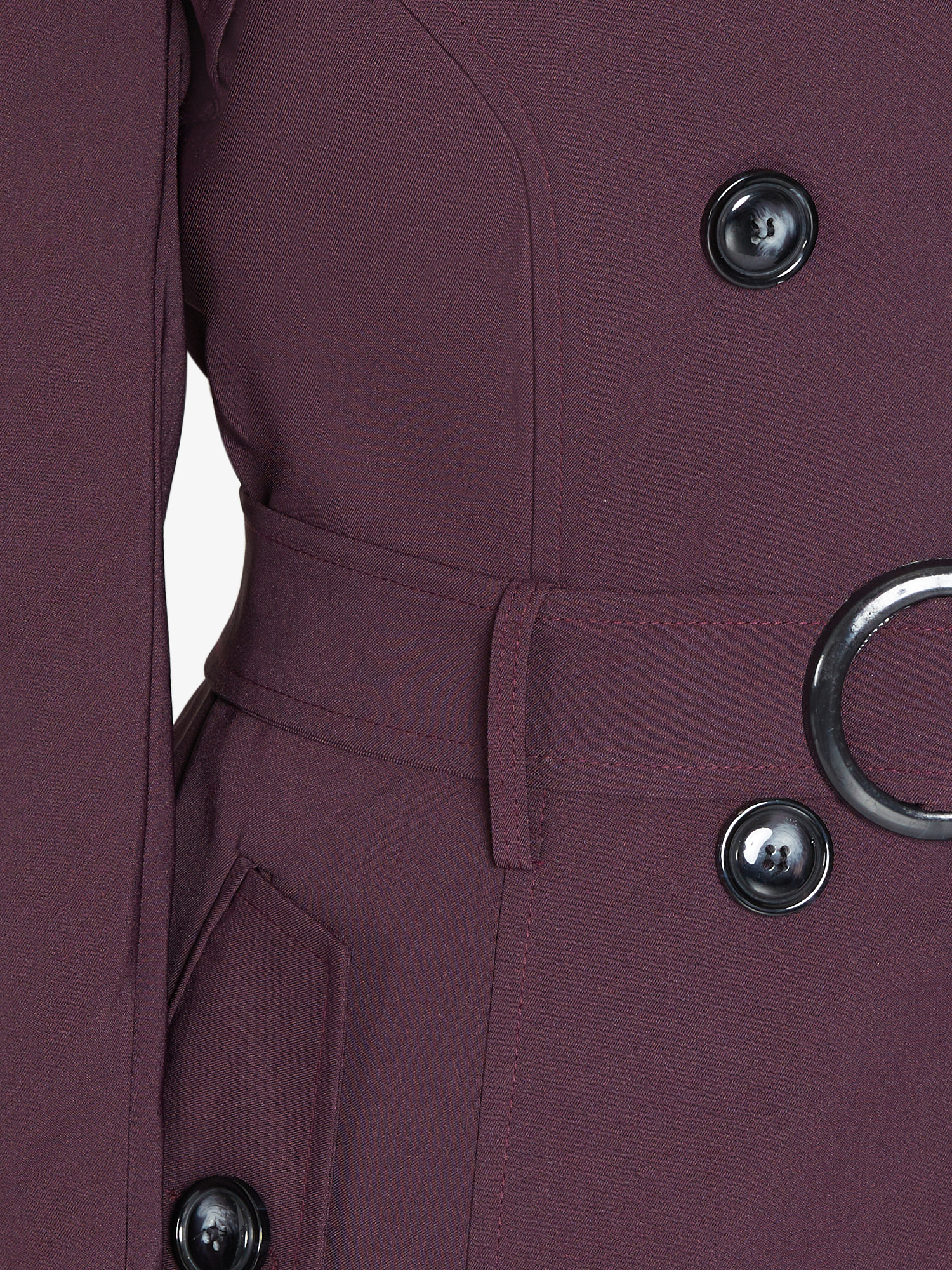 Close-up of a purple coat with buttons and a belt on a white background