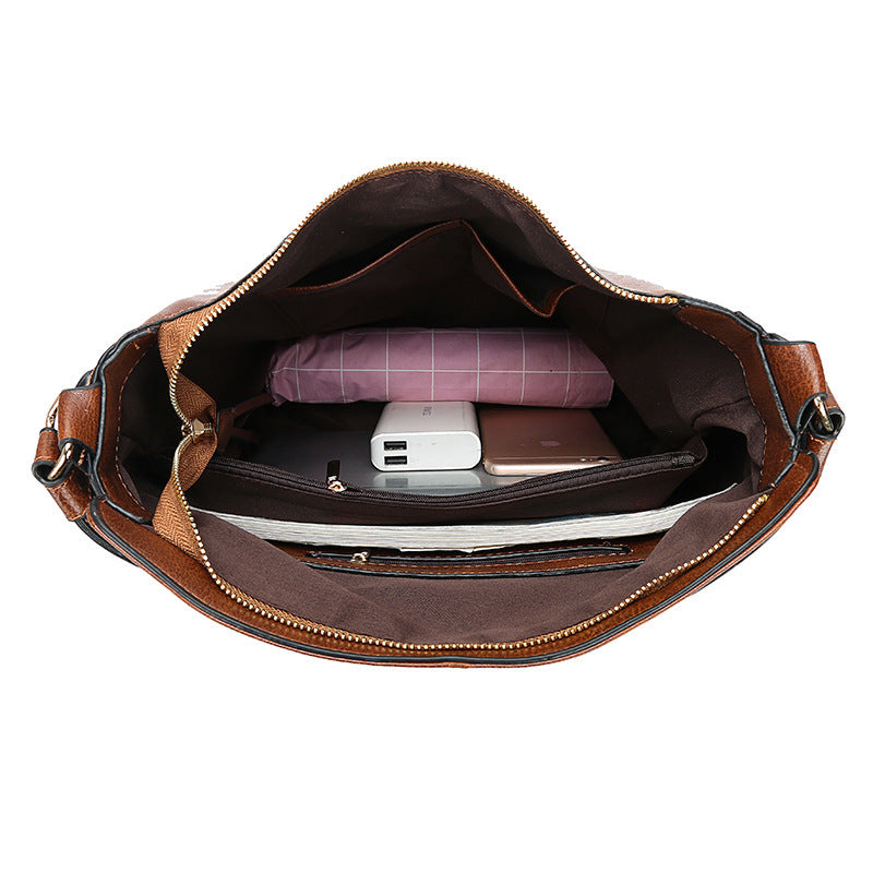 Brown leather bag with items inside on a white background