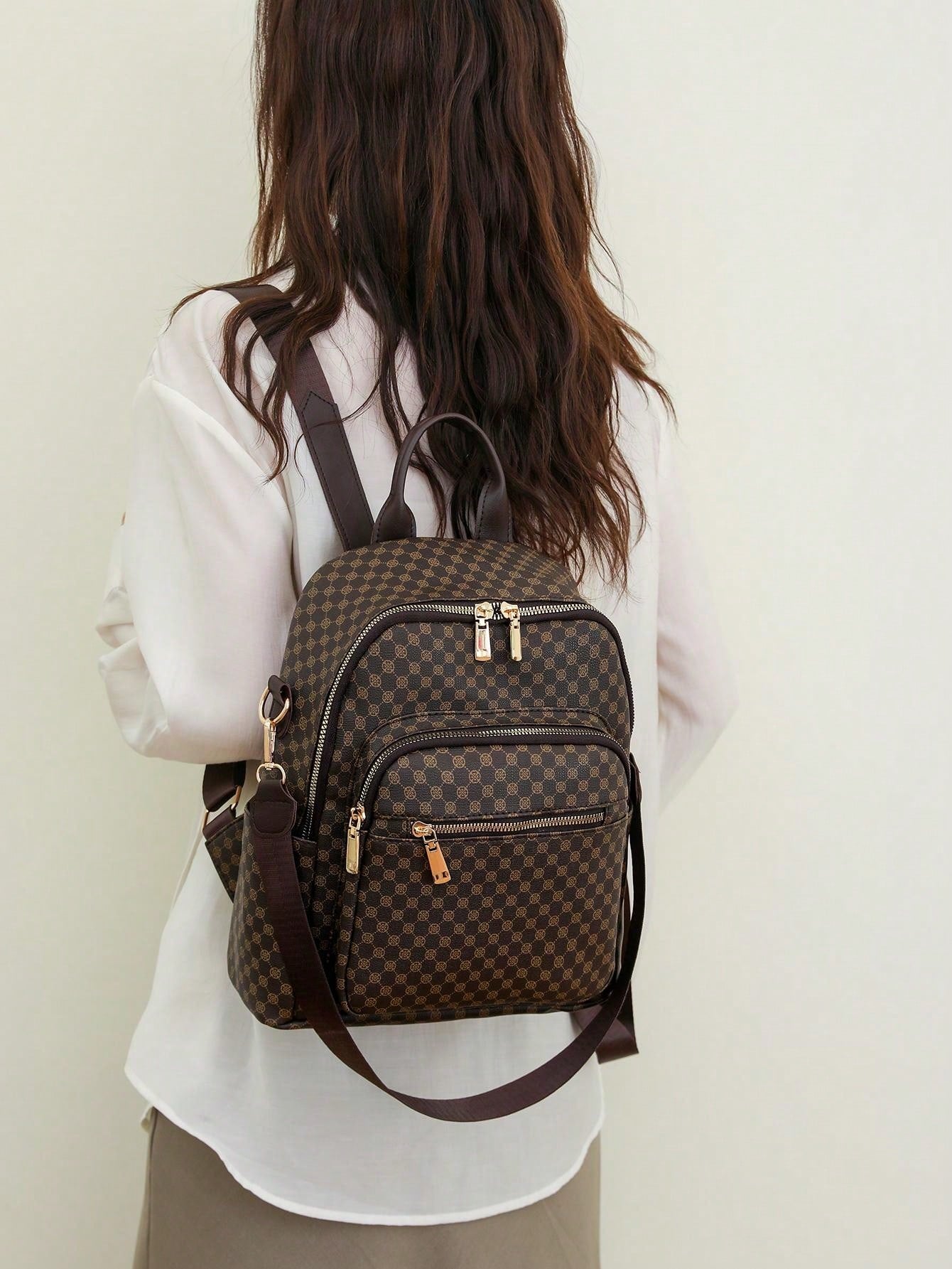 Person wearing a brown patterned backpack against a plain background