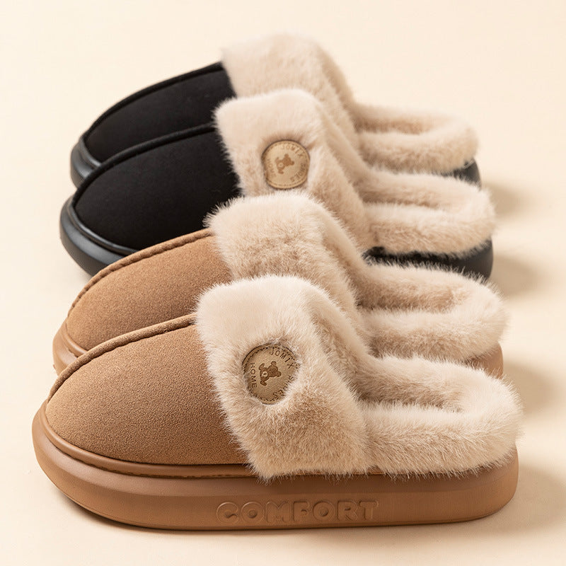 Pair of brown slippers with fluffy trim on a beige background