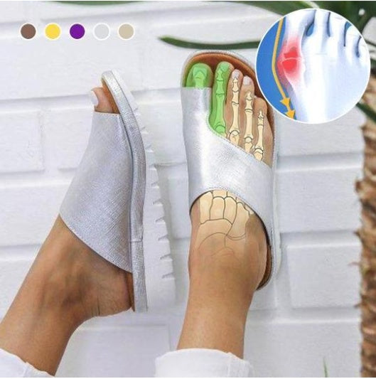 White sandal with a cutaway showing foot anatomy, worn by a person, on a white background.
