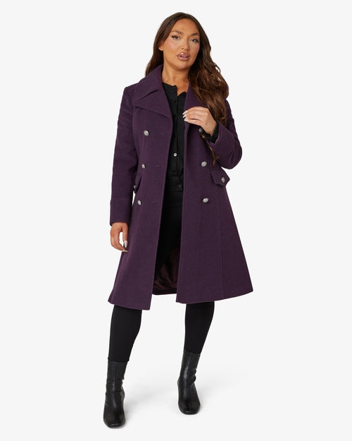 Woman wearing a purple coat on a white background
