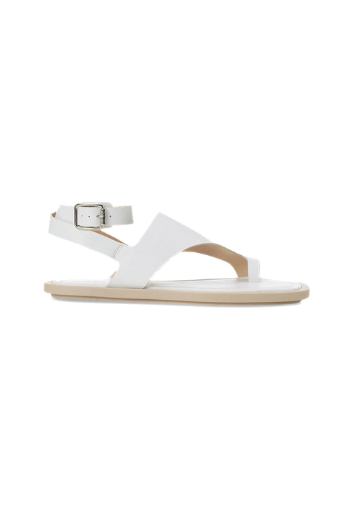 White sandal with a thin strap and small buckle on a white background