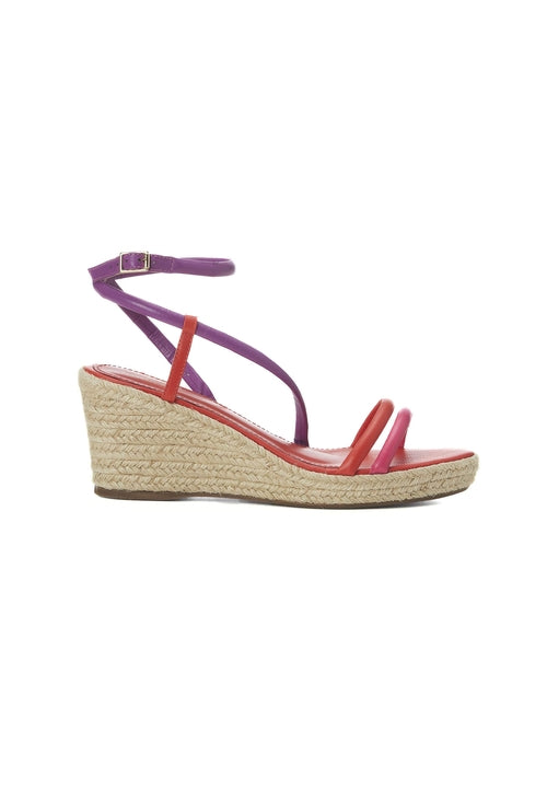 Wedge sandal with purple strap and pink sole on a white background