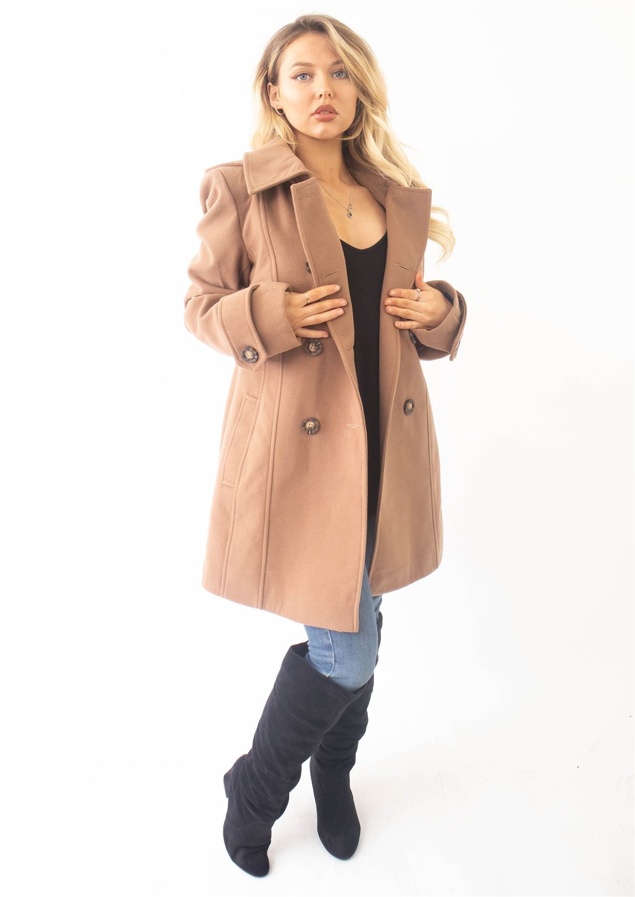 Woman wearing a beige coat on a white background