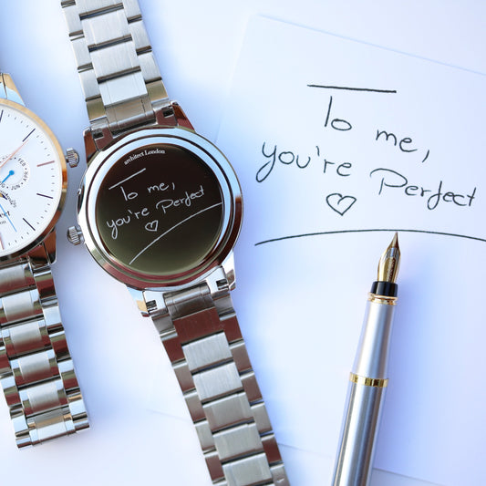 Silver watch with 'To me, you're perfect' message on a white background