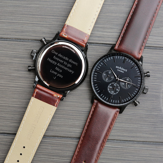 Two watches with leather straps on a textured surface