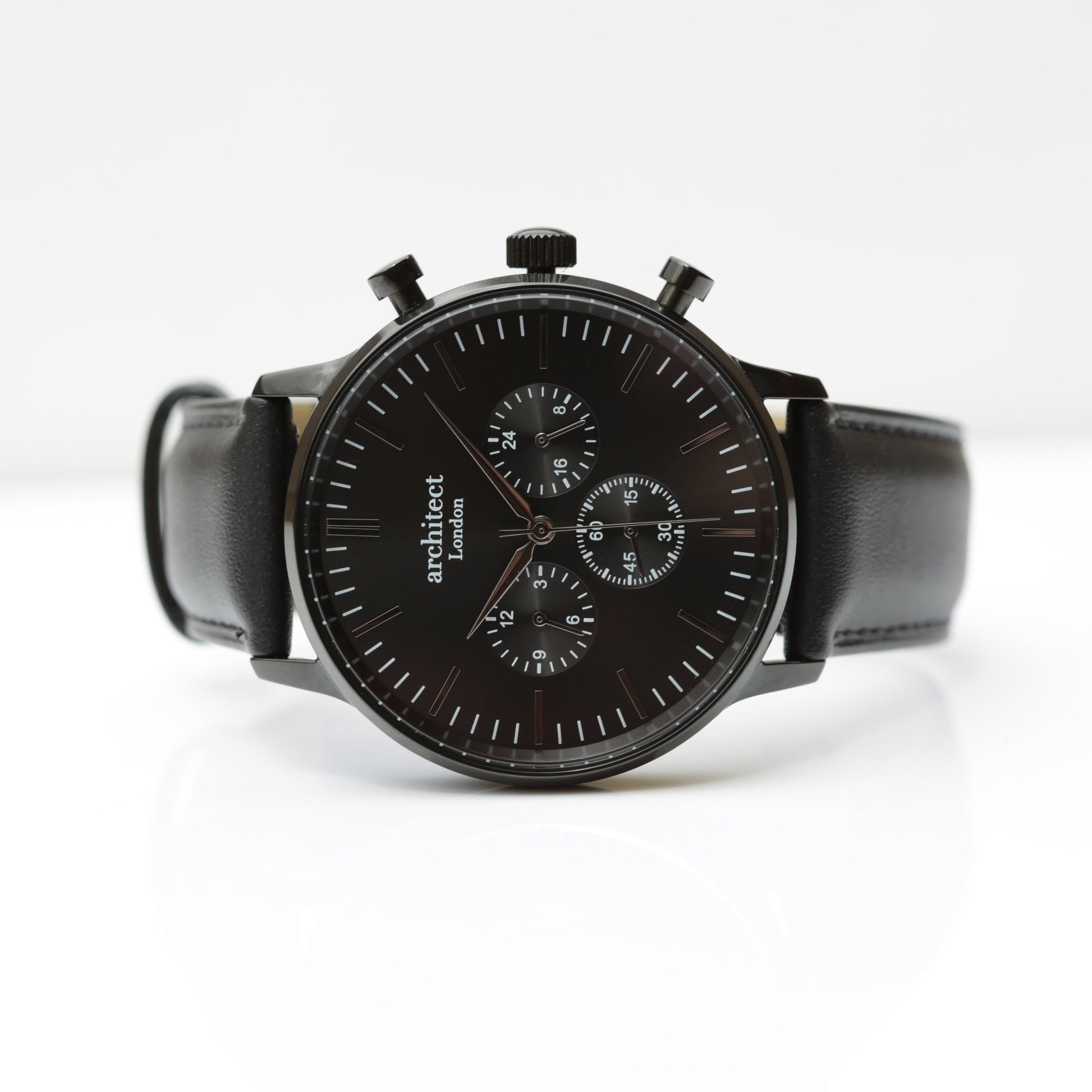 Black watch with a leather strap on a white background