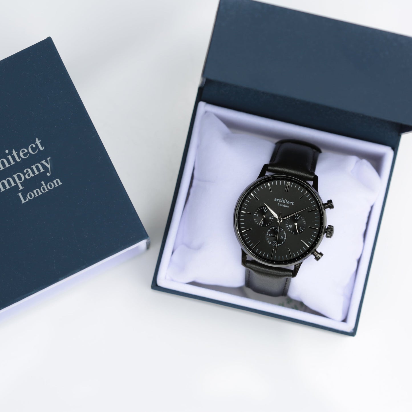 Black watch in a box with 'Architect Company London' branding on a white background