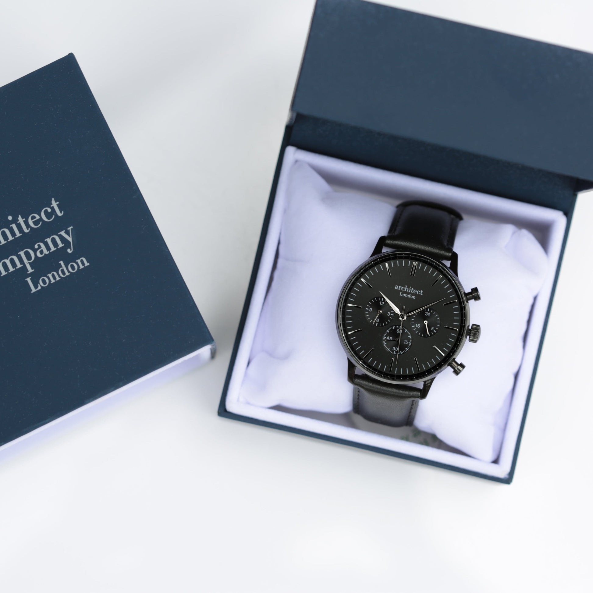 Black watch in a box with 'Architect Company London' branding on a white background