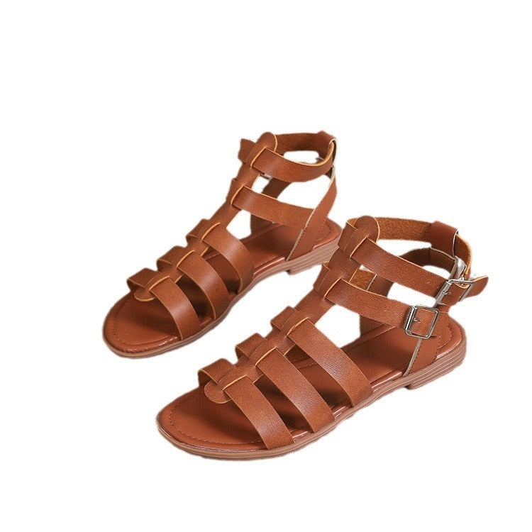 Pair of brown sandals with multiple straps on a white background
