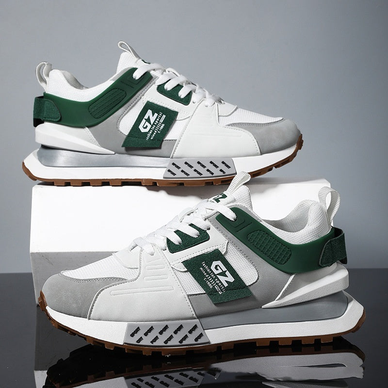 White and gray sneakers with green accents on a reflective surface and gray background