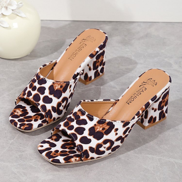 Leopard print mules on a gray surface with 'Fashion' branding.