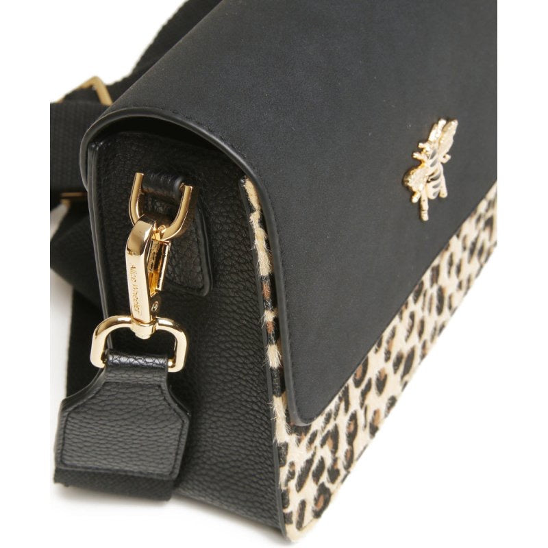 Black handbag with gold clasp and leopard print trim on a white background