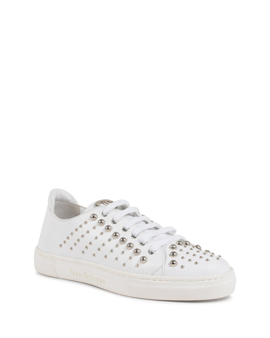 White sneaker with silver studs on a white background