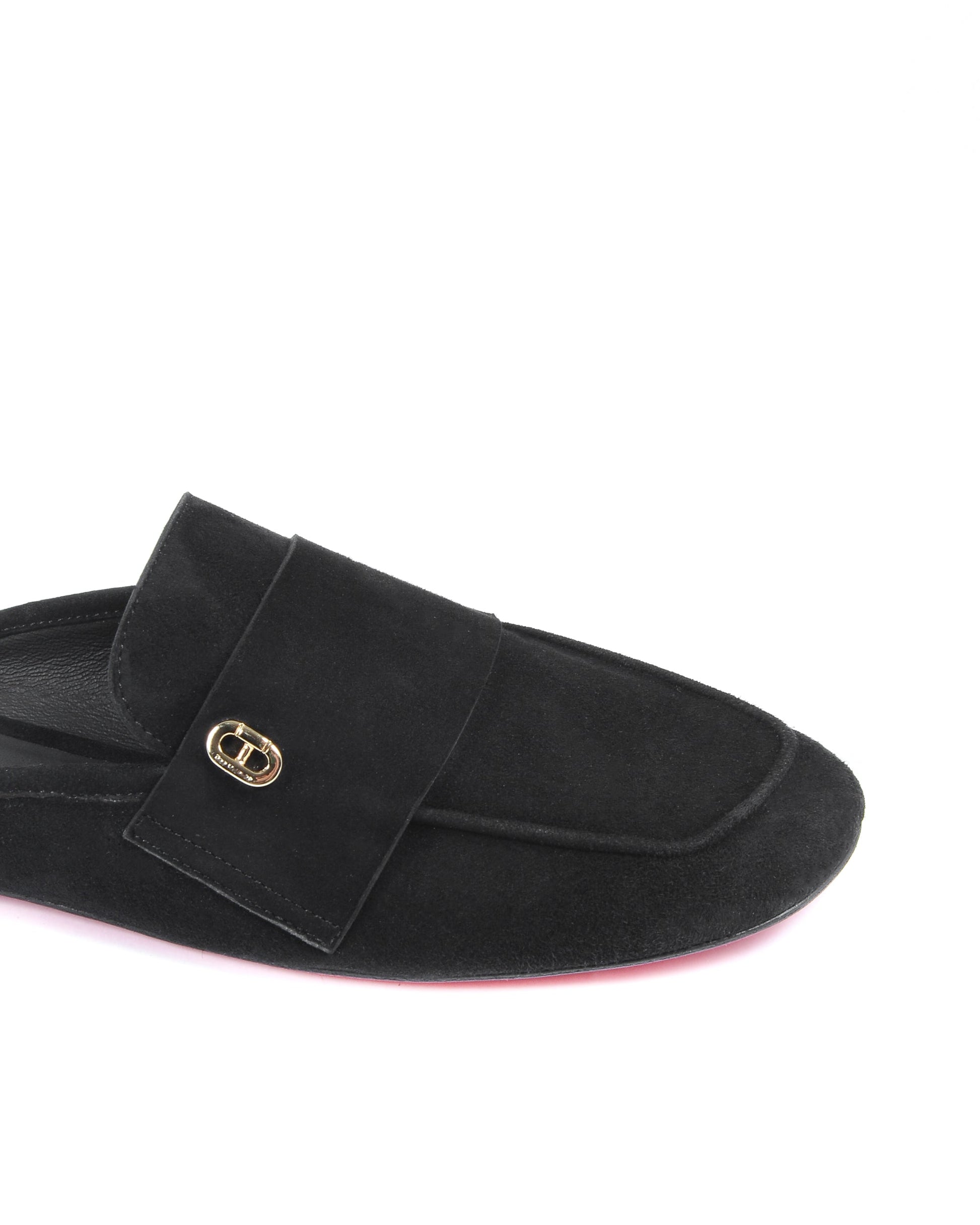 Black slipper with a gold buckle on a white background