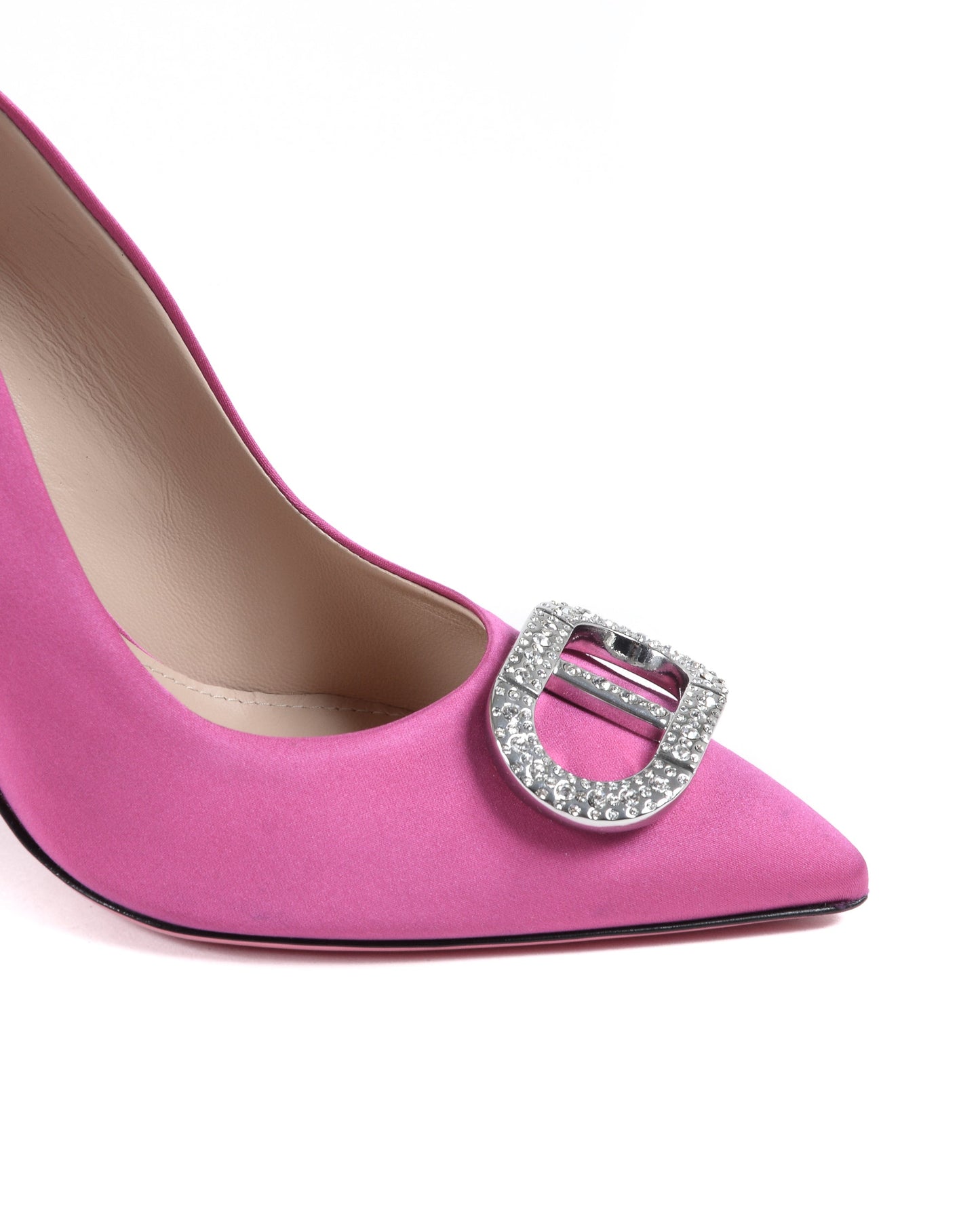 Pink high-heeled shoe with a decorative buckle on a white background
