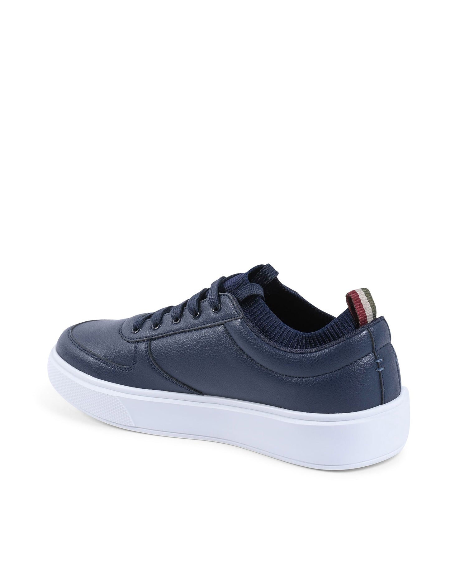 Navy blue sneaker with a white sole on a white background