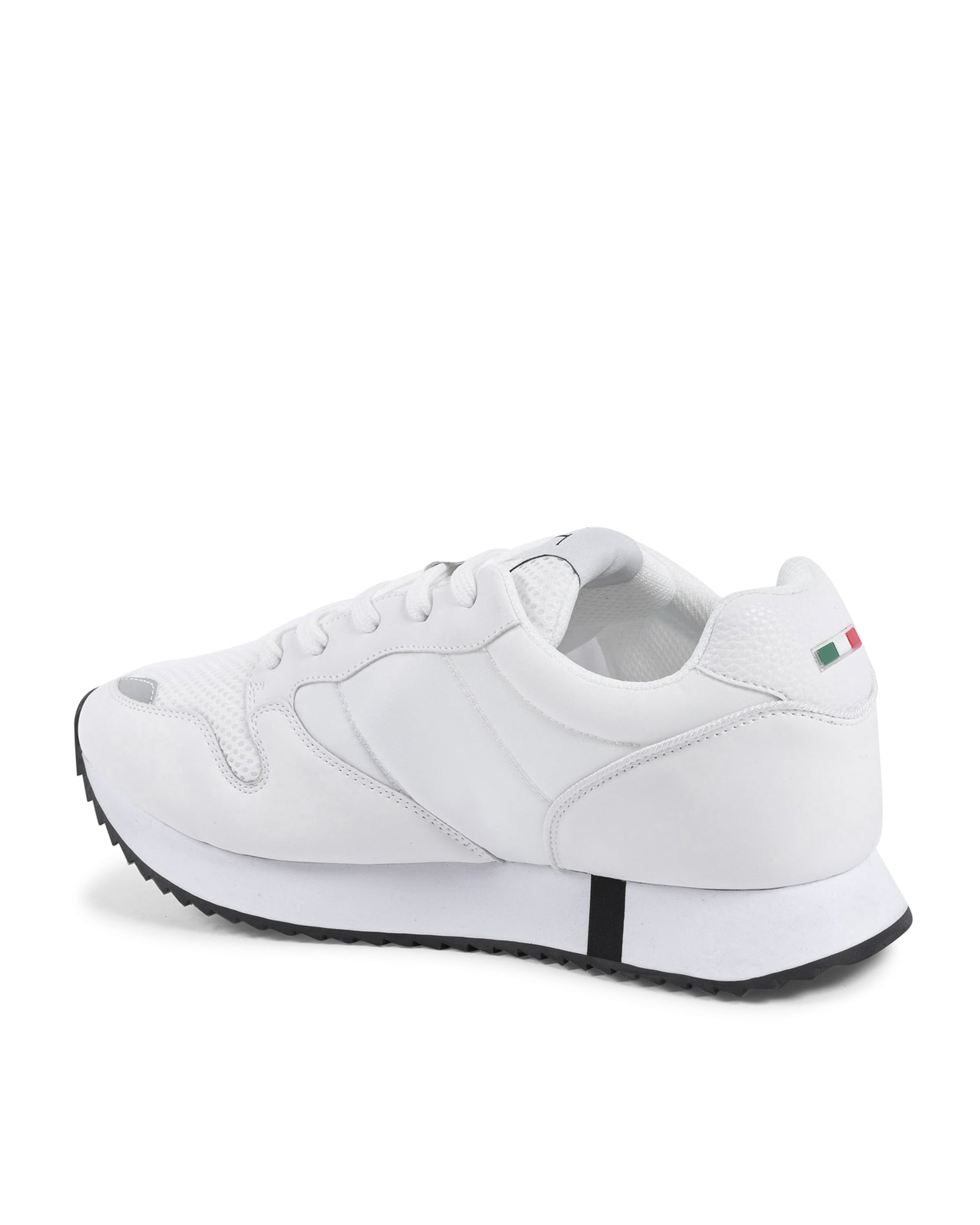 White sneaker with a small flag patch on a white background