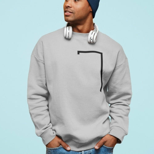 Person wearing a gray sweatshirt with a black design on a light blue background