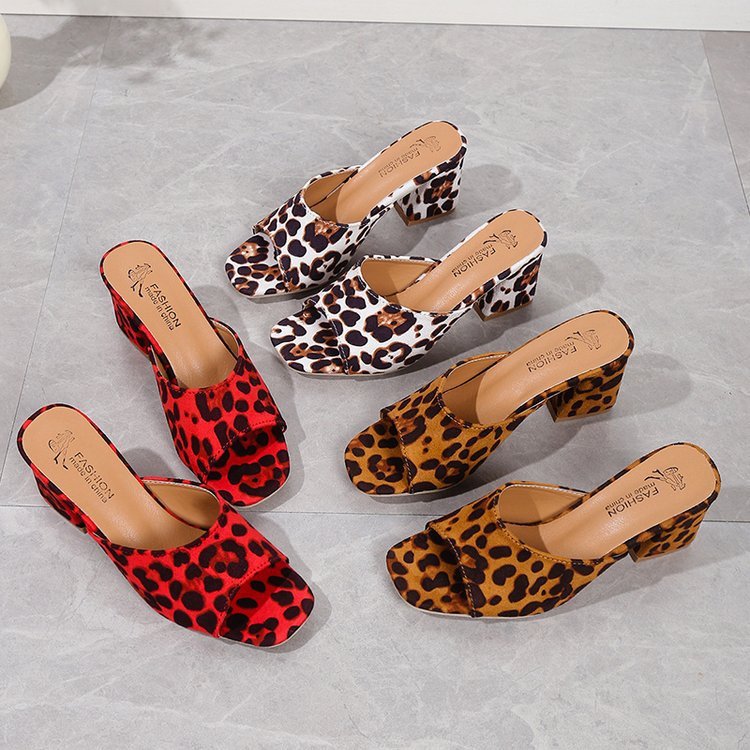 Set of leopard print shoes on a gray surface