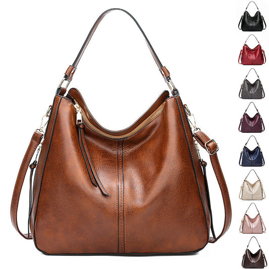 Brown leather handbag with shoulder strap, shown on a white background with color swatches.