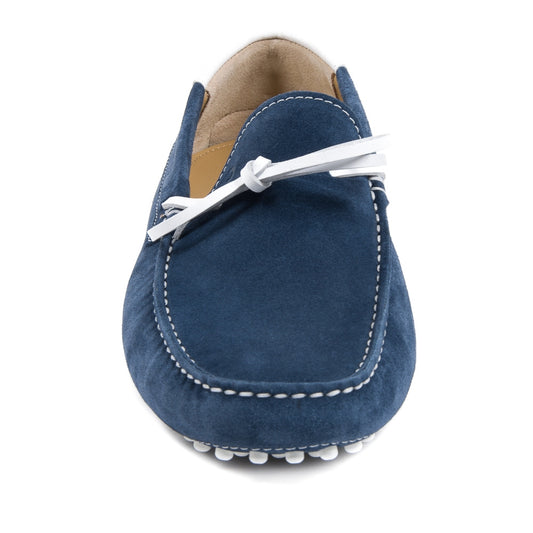 Blue suede loafer with white stitching on a white background