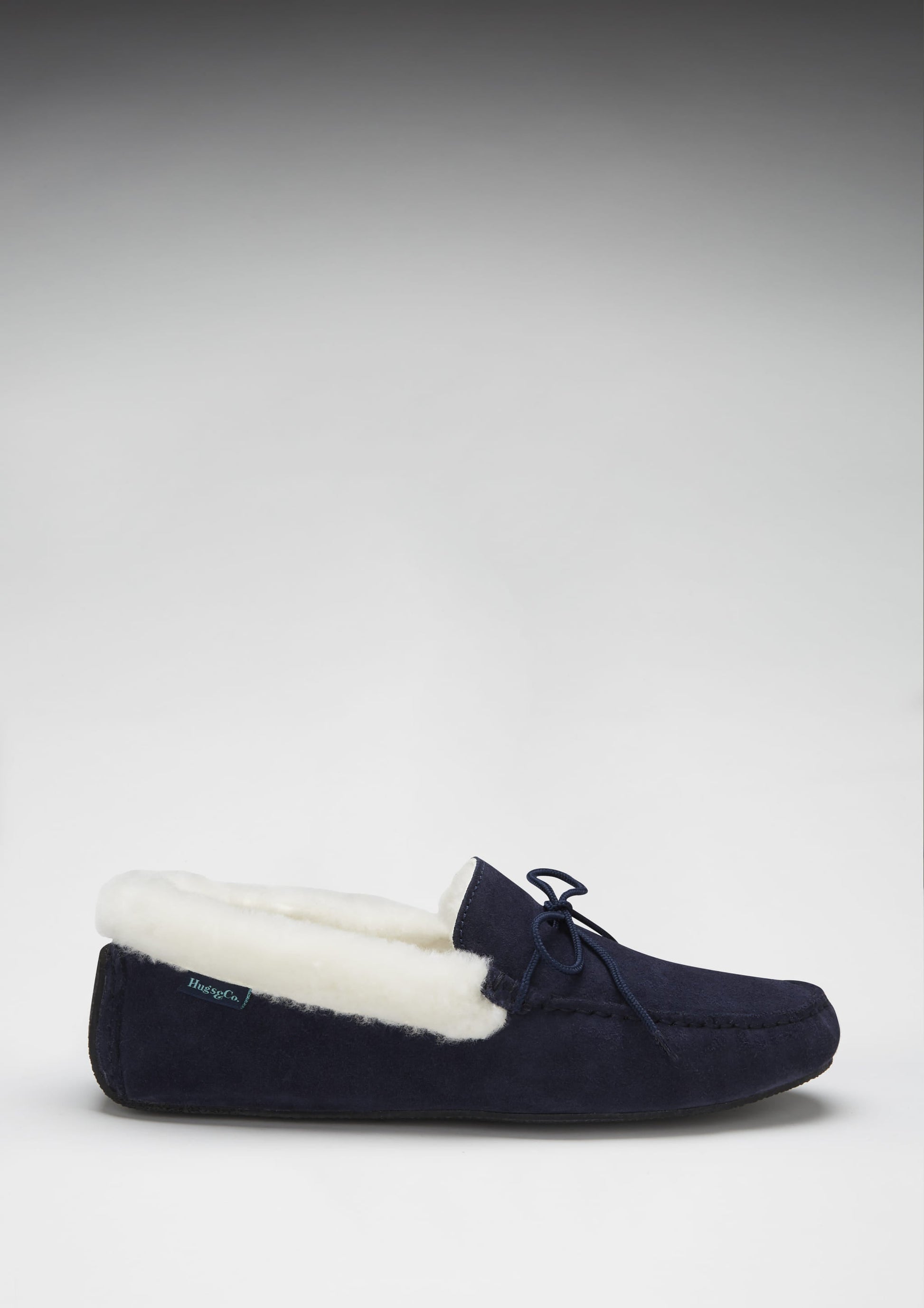 Navy slipper with white lining on a light gray background