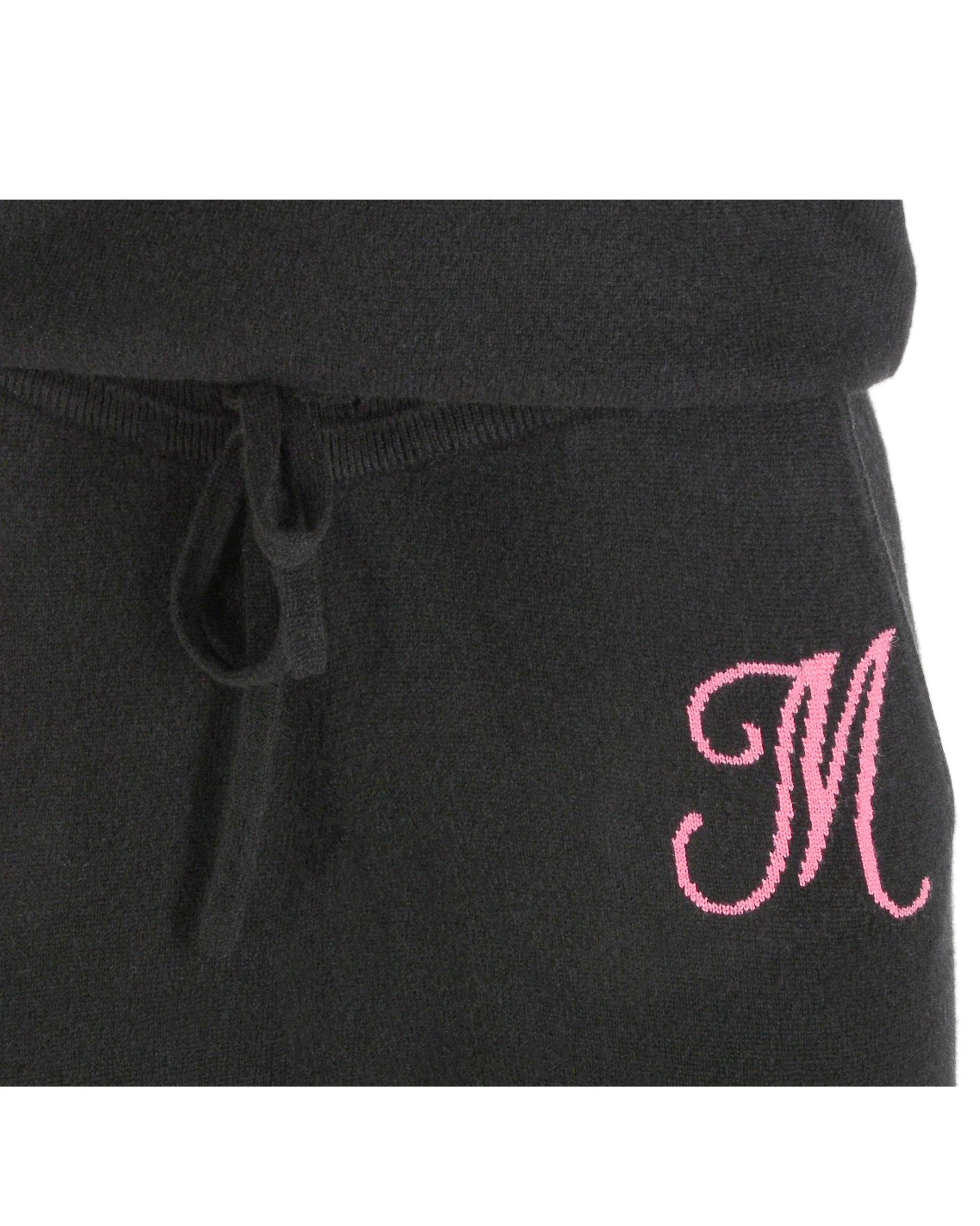 Black sweatpants with a pink embroidered letter 'M' on a white background